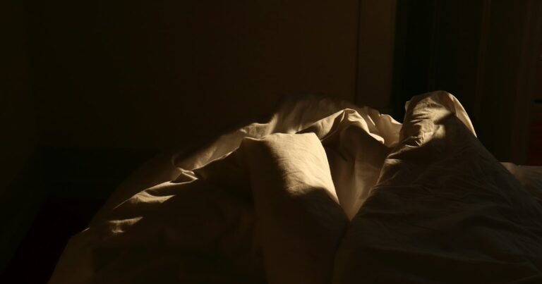 Early morning light falling across folded bed linen