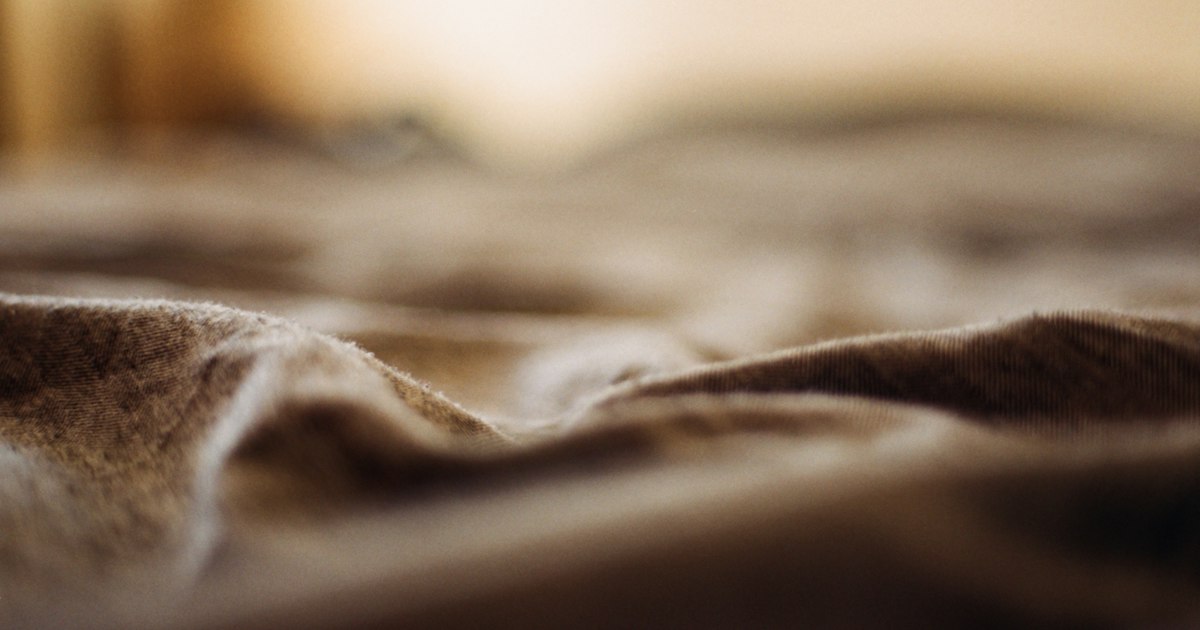 Close-up of soft folds of fabric in warm, hazy light