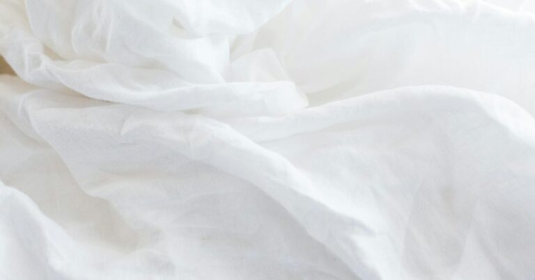 White linen in soft folds lit by early morning light